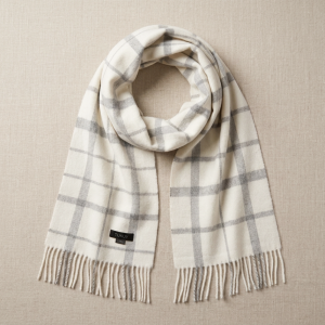Luxury white and gray check alpaca scarf with fringed edges, highlighting its classic heritage pattern and soft natural alpaca wool.