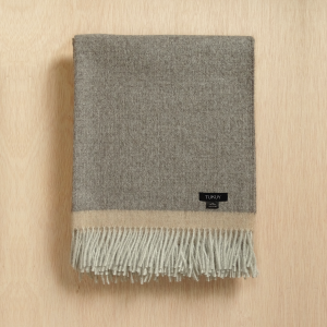 alpaca blanket in gray and beige by Tukuy on top of a wooden background