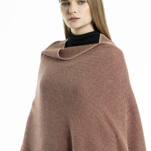 woman wearing a red herringbone-patterned baby alpaca wool scarf from Tukuy with burgundy fringed edges, styled over a black outfit