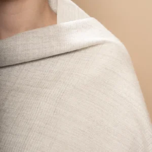 Close up of woman wearing a soft gray baby alpaca wool shawl gradient, unisex luxury made in Peru by Tukuy