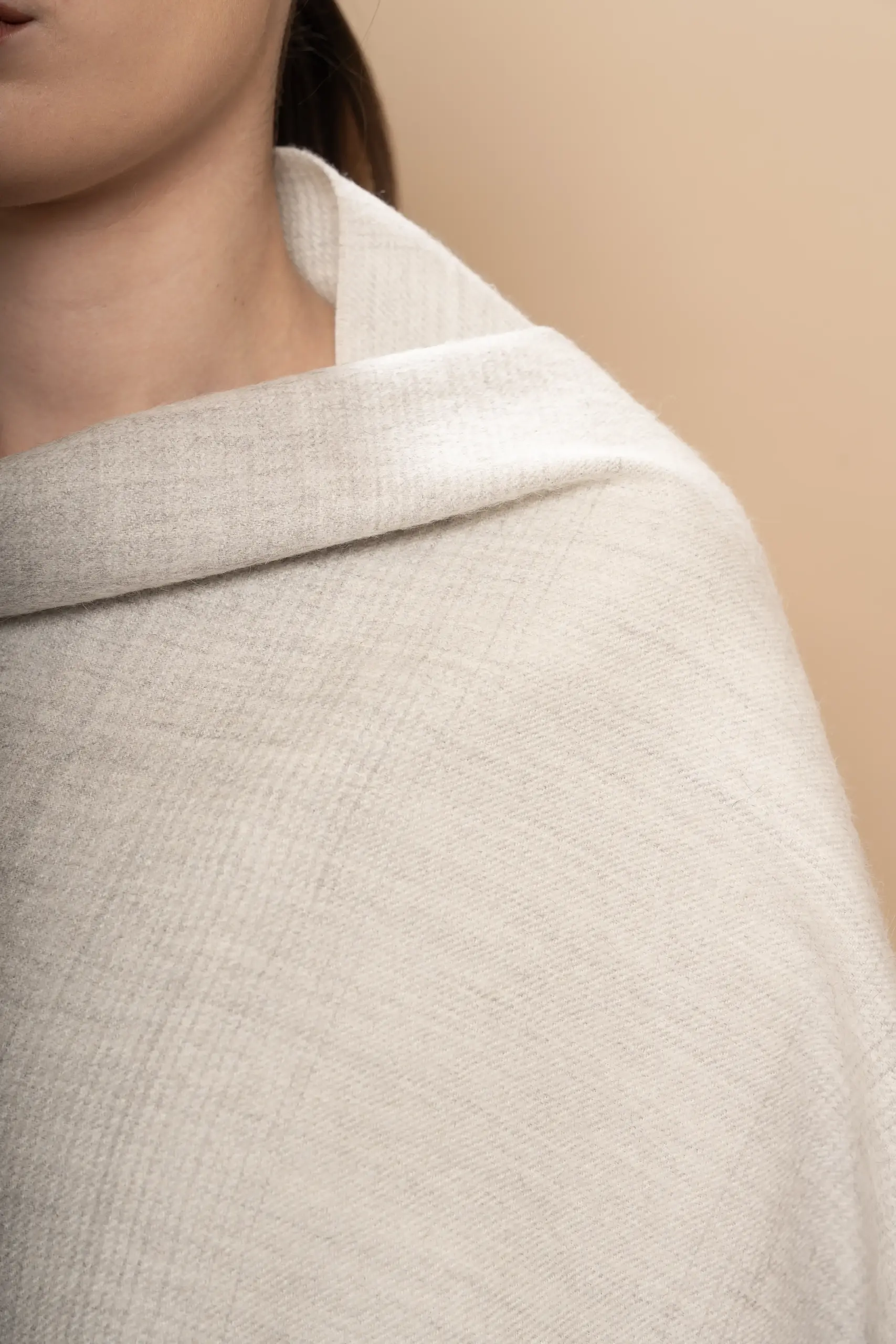 Close up of woman wearing a soft gray baby alpaca wool shawl gradient, unisex luxury made in Peru by Tukuy