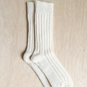 alpaca socks on top of a wooden table crew socks by tukuy