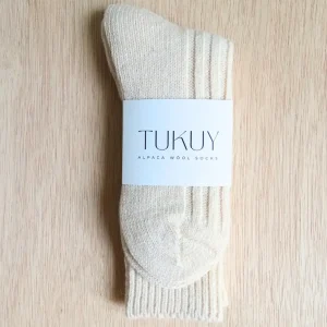 alpaca socks by tukuy on top of a wooden table