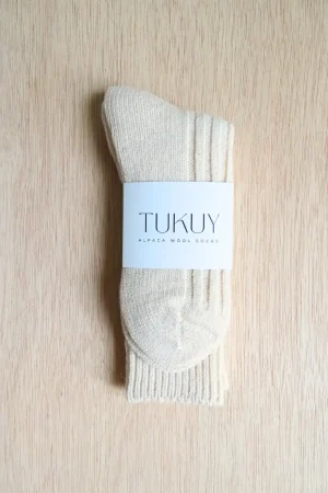 alpaca socks by tukuy on top of a wooden table