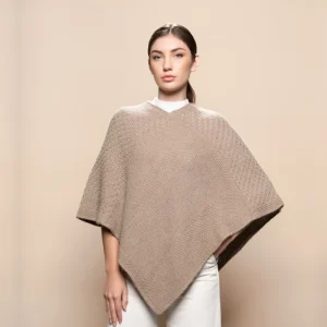 woman wearing a poncho in beige color made from baby alpaca
