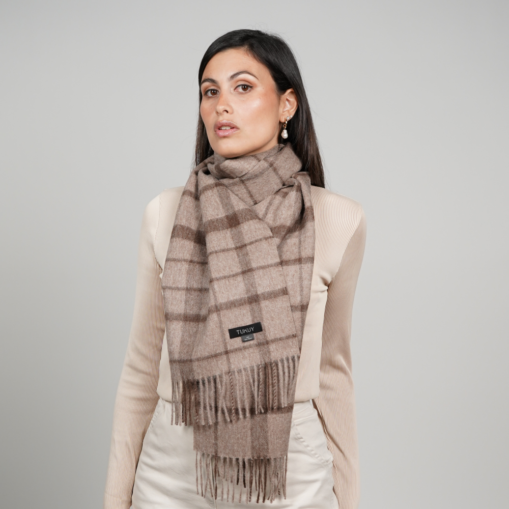 Woman wearing the Alpaca Scarf in Brown Check, combining a timeless heritage pattern with warm neutral tones for a sophisticated and versatile winter look.