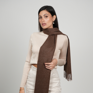 Woman wearing a chocolate brown alpaca scarf made from 100% baby alpaca wool, showcasing its rich natural brown color, elegant drape, and timeless winter style.
