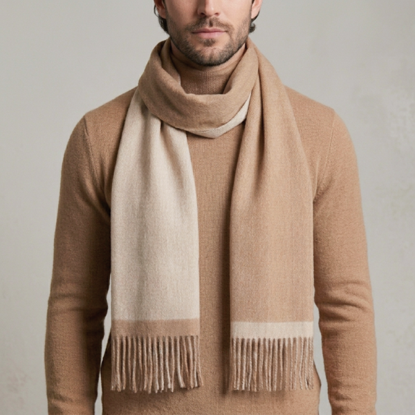 man wearing a reversible camel and beige alpaca scarf made from natural alpaca wool, featuring ultra-soft texture, warm natural tones, and a timeless design that complements neutral outfits.