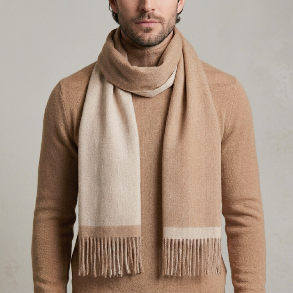 man wearing a reversible camel and beige alpaca scarf made from natural alpaca wool, featuring ultra-soft texture, warm natural tones, and a timeless design that complements neutral outfits.
