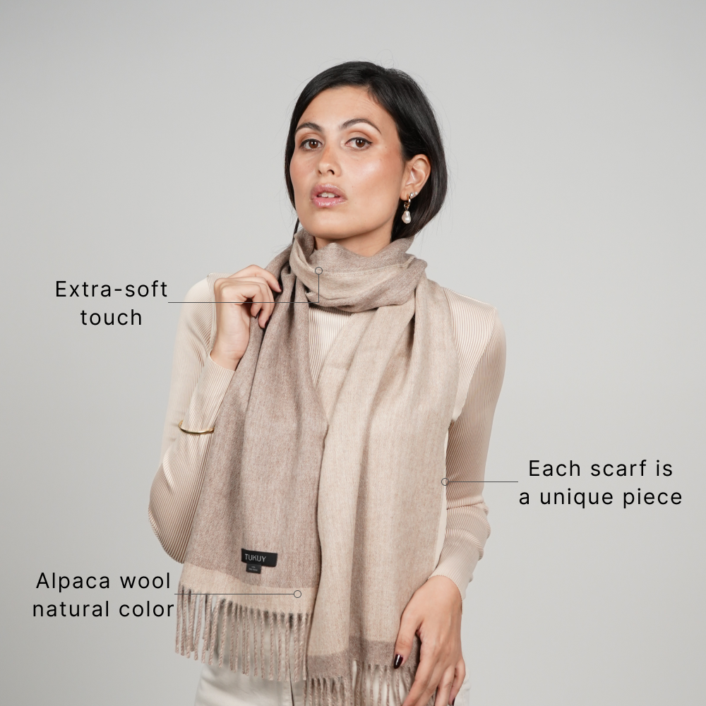 Woman wearing a reversible beige alpaca wool scarf made from natural alpaca fiber, featuring an ultra-soft feel, unique natural color variations, and elegant everyday style.