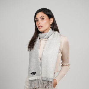 Reversible gray alpaca wool scarf worn with neutral clothing, featuring natural gray tones, exceptional softness, and timeless styling.