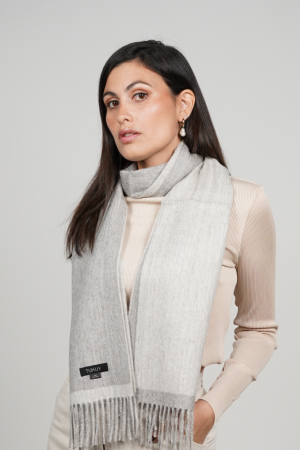 Reversible gray alpaca wool scarf worn with neutral clothing, featuring natural gray tones, exceptional softness, and timeless styling.