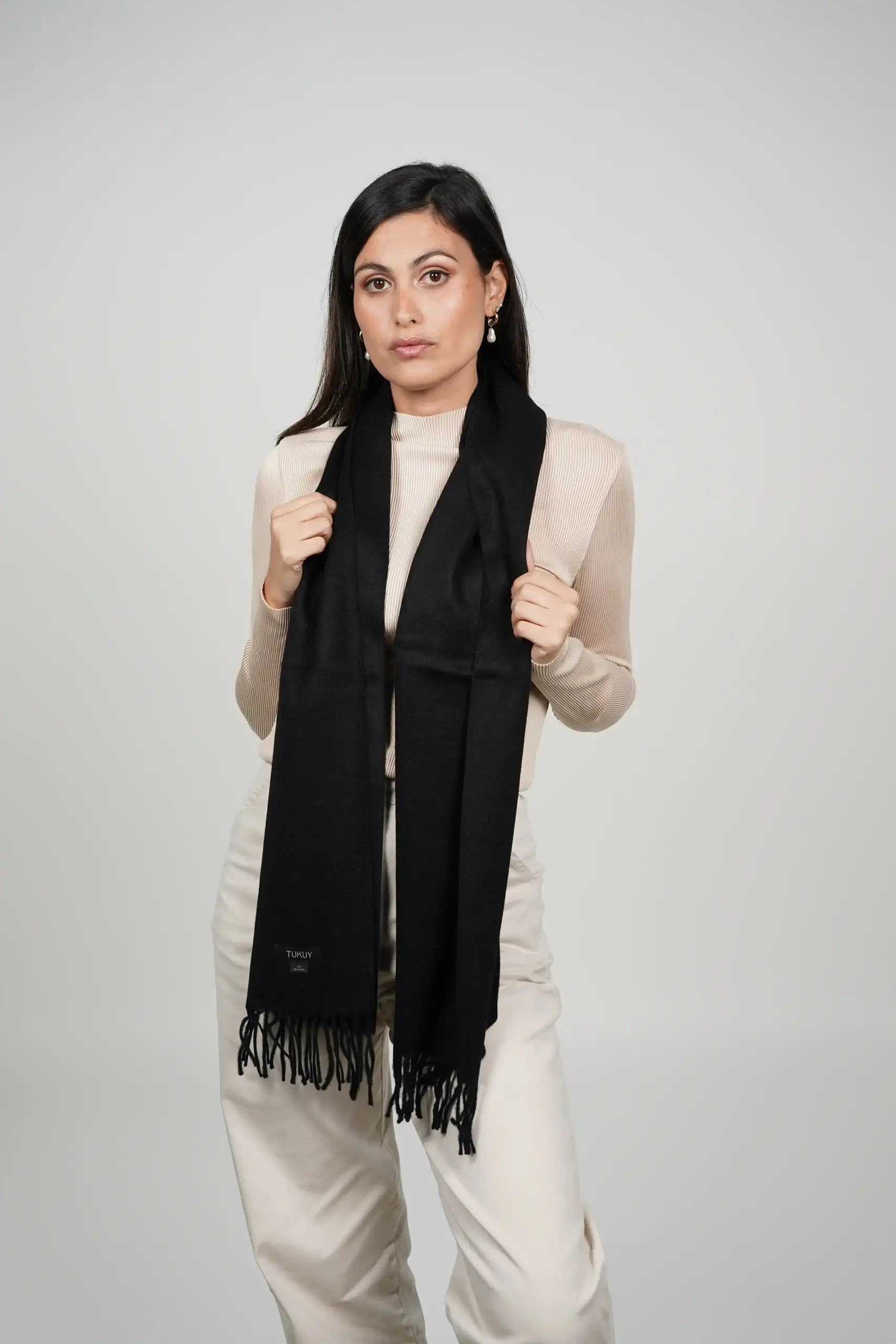 women wearing a black alpaca scarf, soft and made by Tukuy Brand