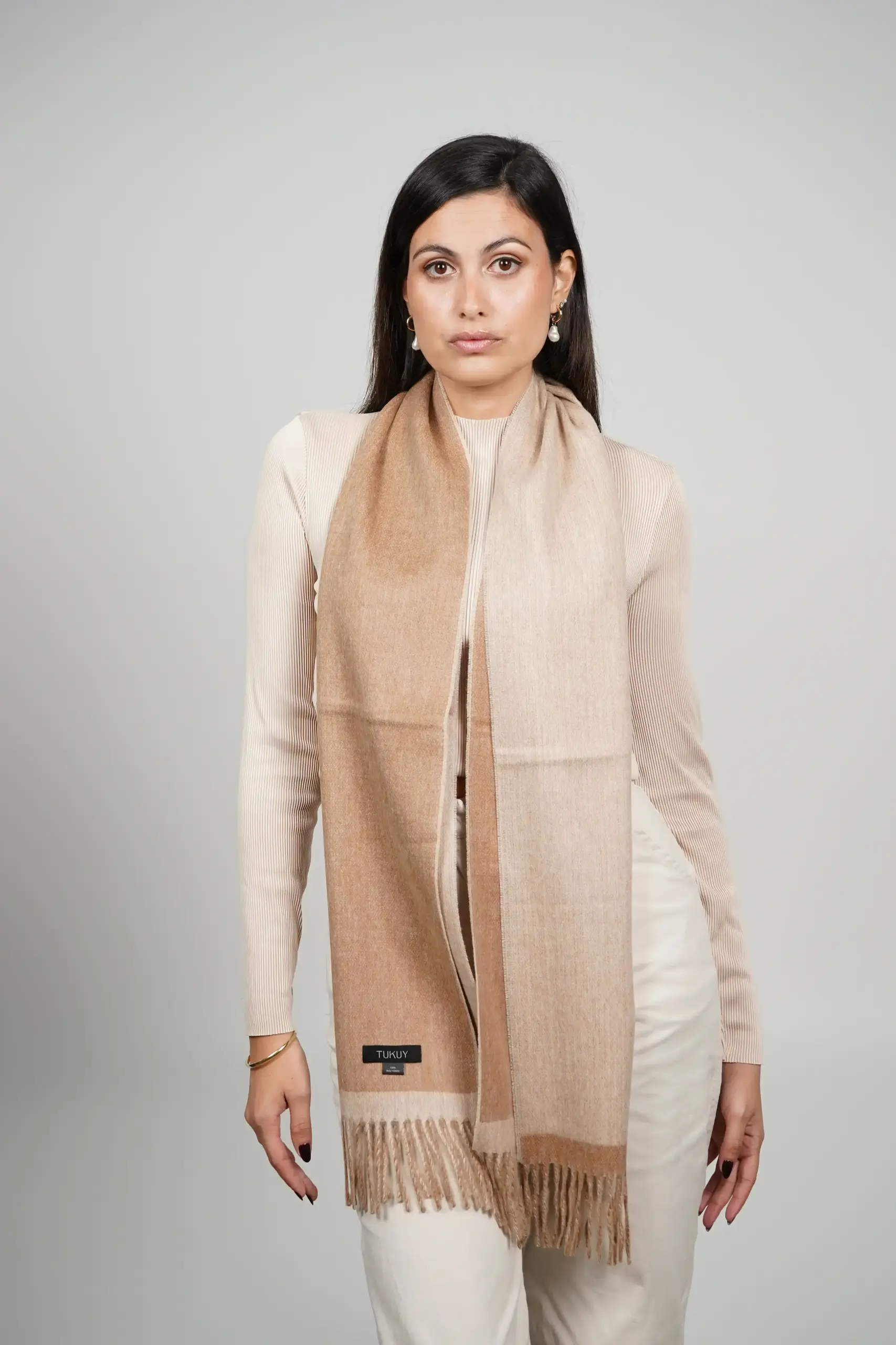 women wearing a camel alpaca scarf, camel and beige reversible scarf made with 100% baby alpaca wool by Tukuy Brand