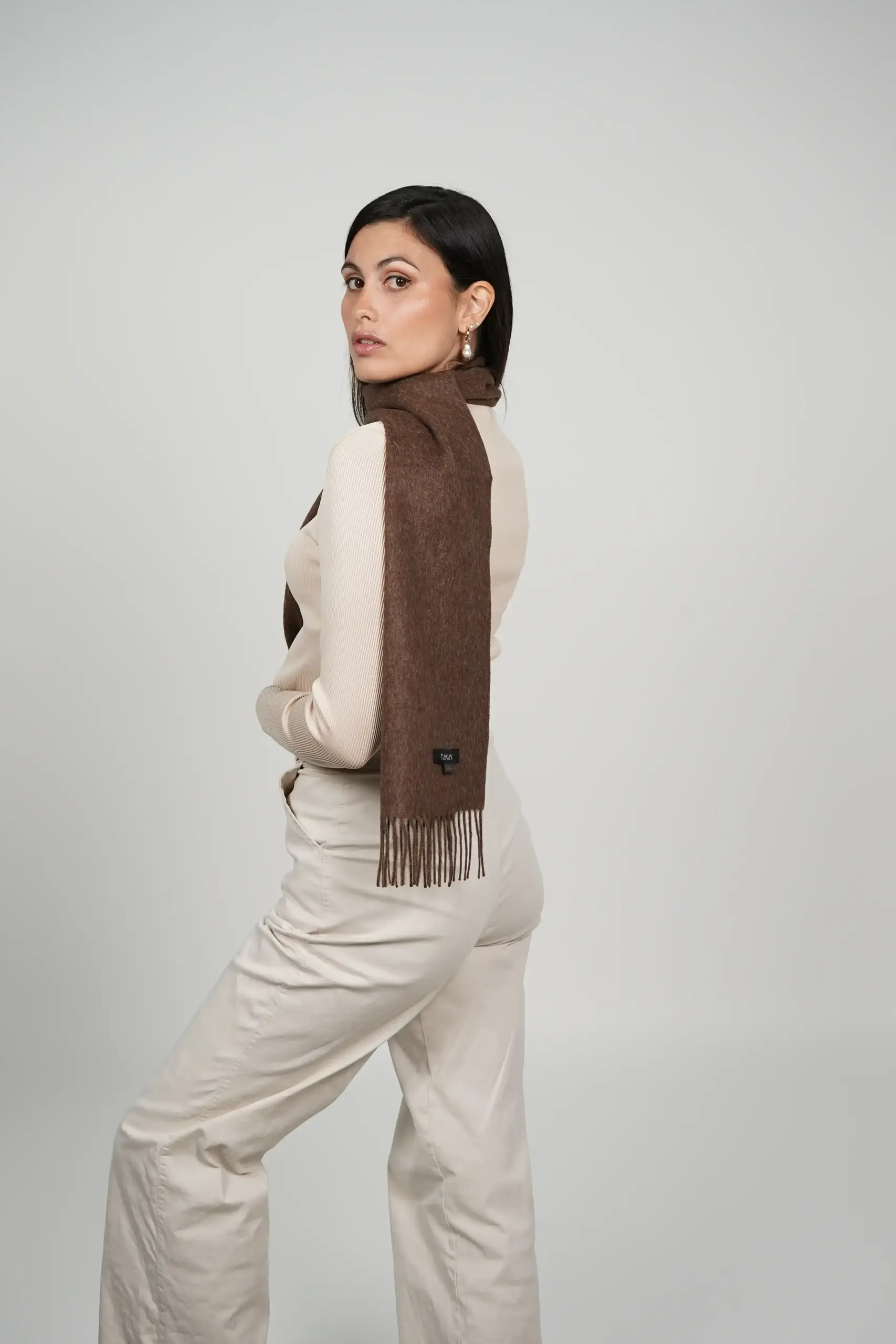 women wearing a luxurious scarf in brown. alpaca scarf in chocolate brown by tukuy brand