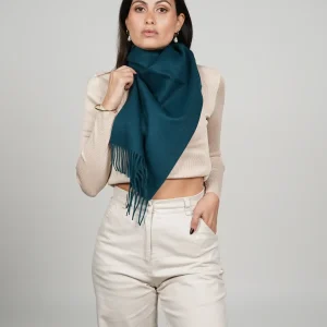 Women wearing a luxurious green scarf designed by tukuy brand. alpaca scarf in green
