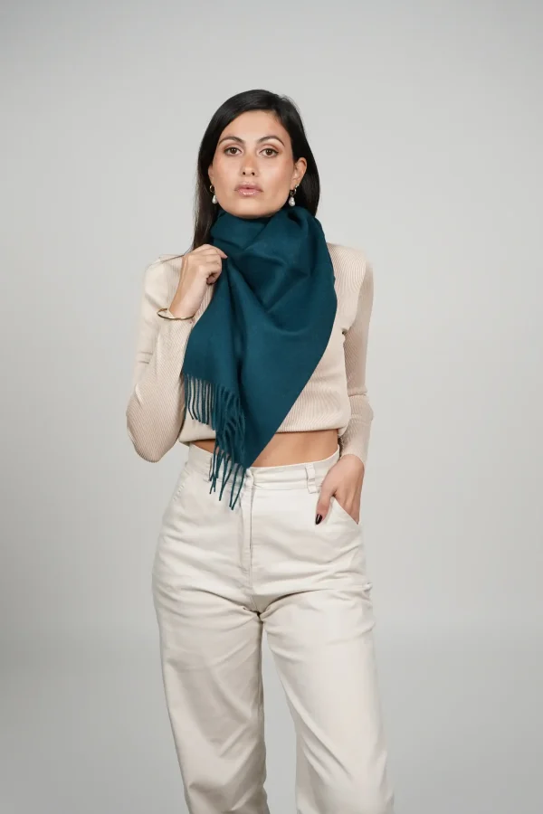 Women wearing a luxurious green scarf designed by tukuy brand. alpaca scarf in green
