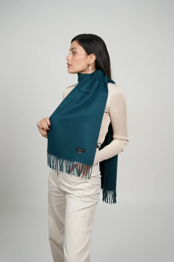 Women wearing a luxurious green scarf designed by tukuy brand. alpaca scarf in green