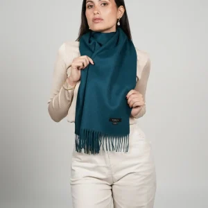 alpaca scarf in green. Women wearing a luxurious green scarf designed by tukuy brand.