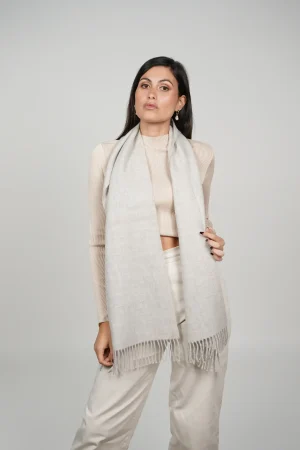 alpaca scarf in grey. Women wearing a luxurious grey scarf designed by tukuy brand.