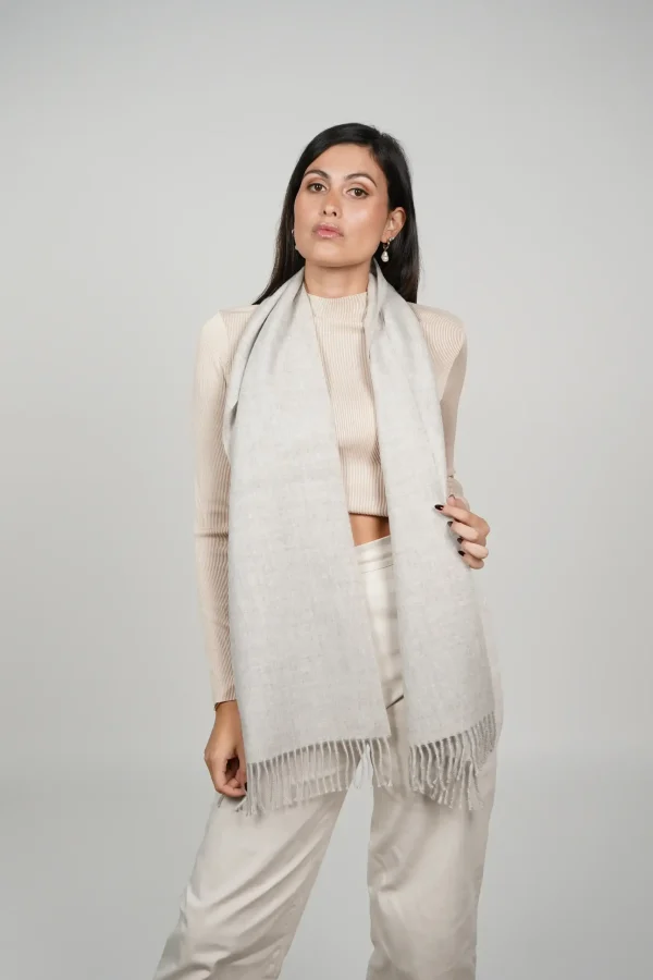 alpaca scarf in grey. Women wearing a luxurious grey scarf designed by tukuy brand.