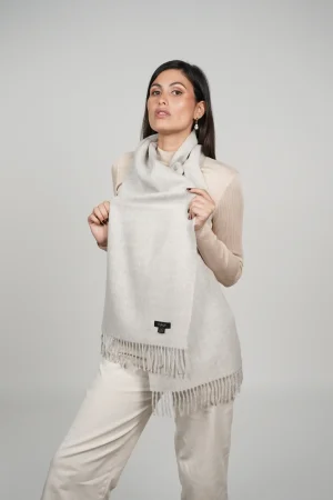 alpaca scarf in grey. Women showing a luxurious grey scarf designed by tukuy brand.
