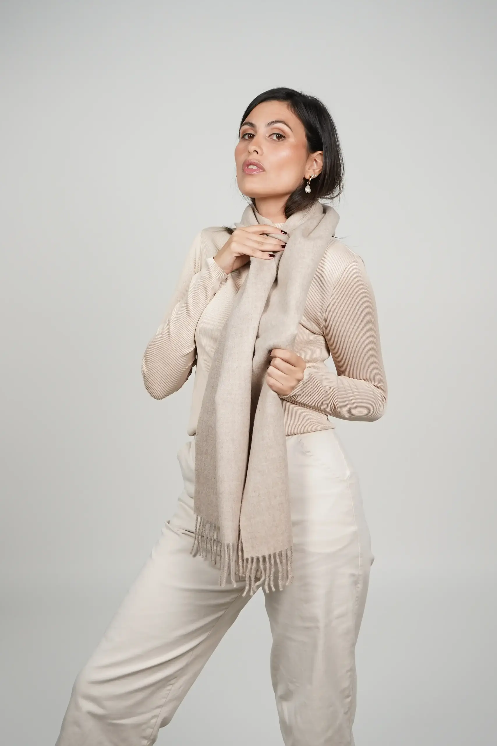 alpaca scarf in oatmeal tone. Women wearing a luxurious oatmeal scarf designed by tukuy brand.