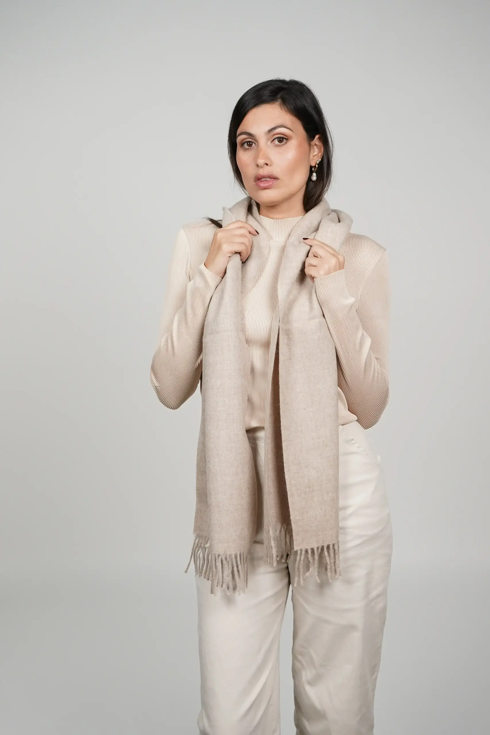 alpaca scarf in natural color oatmeal tone. Women wearing a luxurious oatmeal scarf designed by tukuy brand.