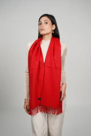 alpaca scarf in intense red. Women wearing a luxurious red scarf designed by tukuy brand.
