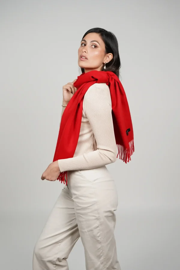 alpaca scarf in intense red. Women wearing a luxurious red scarf designed by tukuy brand.