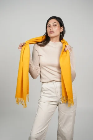 alpaca scarf in yellow. intense yellow color scarf by tukuy brand. women wearing an alpaca scarf in yellow.