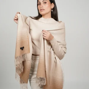 women wearing a beige alpaca shawl in natural color of alpaca wool. luxurious touch and nice drape by tukuy brand