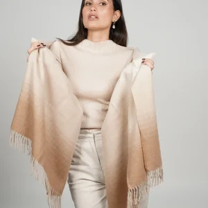 women wearing a beige alpaca shawl in natural color of alpaca wool. luxurious touch and nice drape by tukuy brand