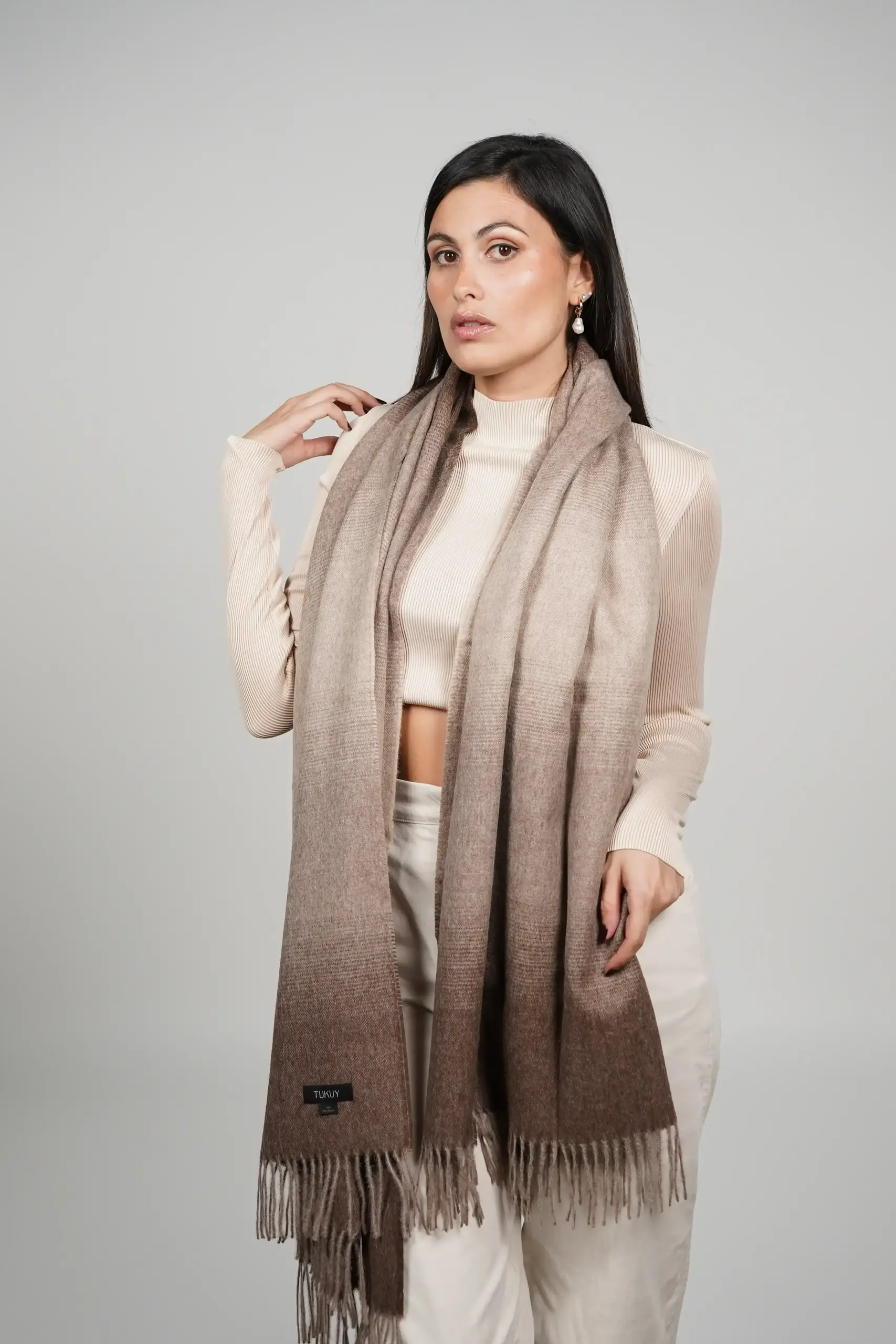 women wearing a brown alpaca shawl in natural color of alpaca wool. luxurious touch and nice drape by tukuy brand