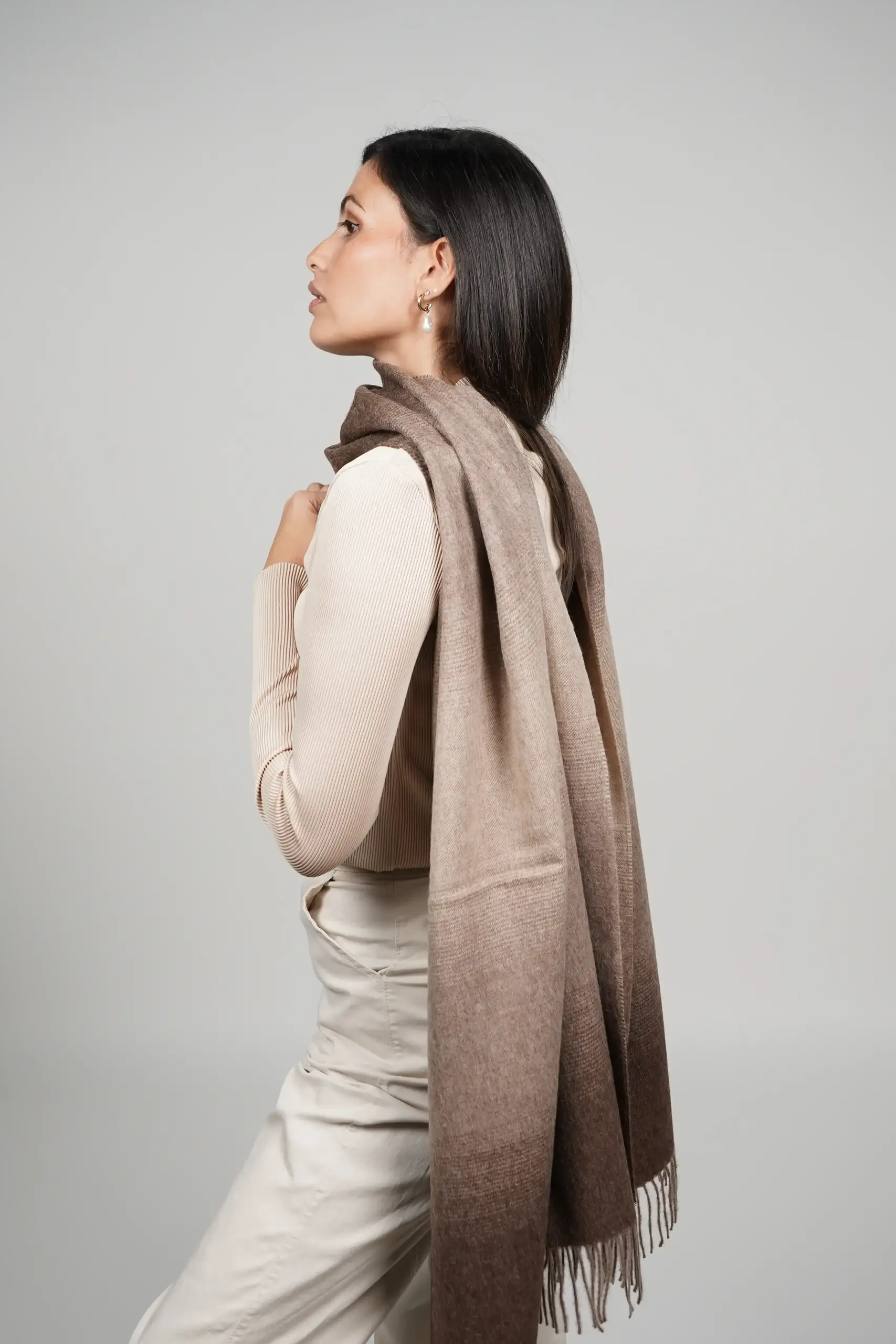 women wearing a brown gradient alpaca shawl in natural color of alpaca wool. luxurious touch and nice drape by tukuy brand