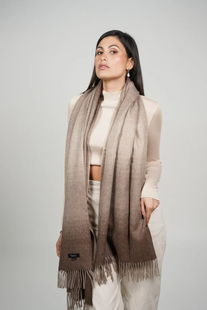 women wearing a brown alpaca shawl in natural color of alpaca wool. luxurious touch and nice drape by tukuy brand