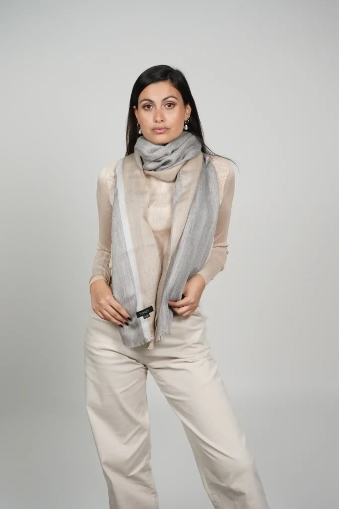 women wearing a gray and beige alpaca shawl made in peru with alpaca and silk soft and made by Tukuy Brand