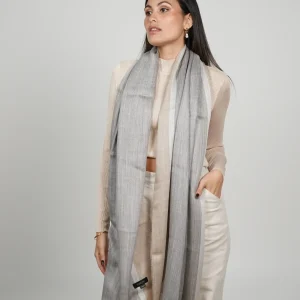 women wearing a gray and beige alpaca shawl with silk. Made in peru, alpaca and silk shawl made by Tukuy Brand