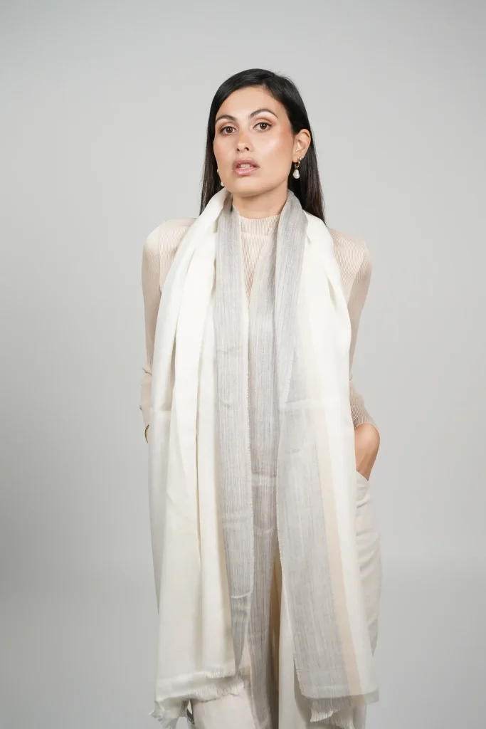 women wearing a white alpaca shawl with silk. Alpaca and silk shawl made by Tukuy Brand