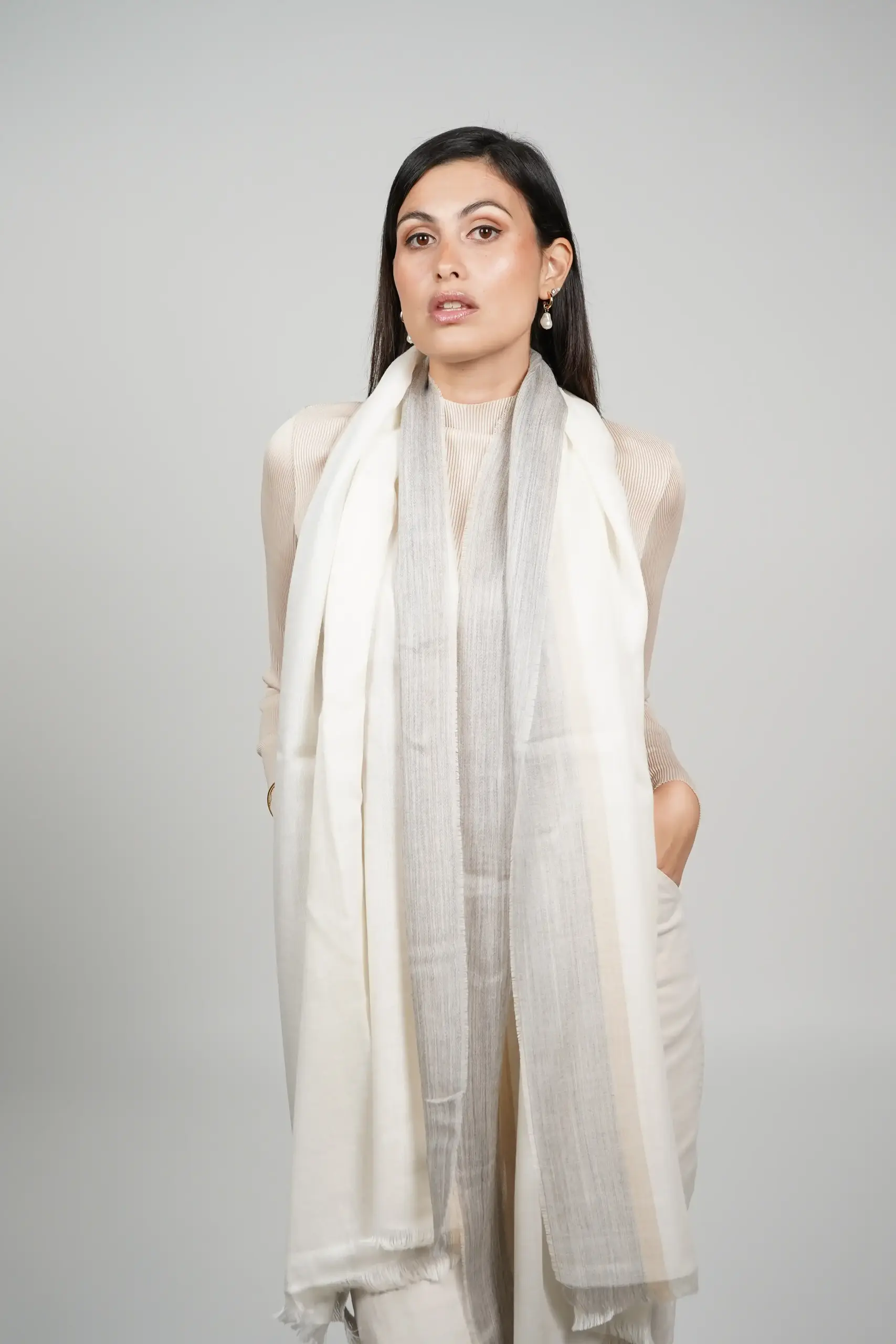 women wearing a white alpaca shawl with silk. Alpaca and silk shawl made by Tukuy Brand