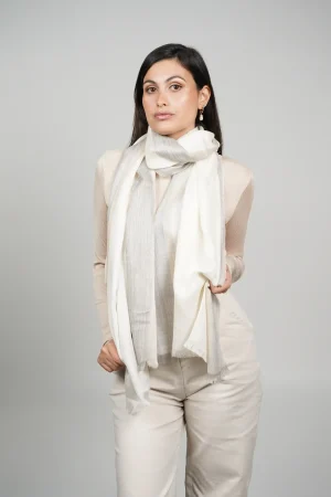 women wearing a white and gray alpaca shawl with silk. Alpaca and silk shawl made by Tukuy Brand