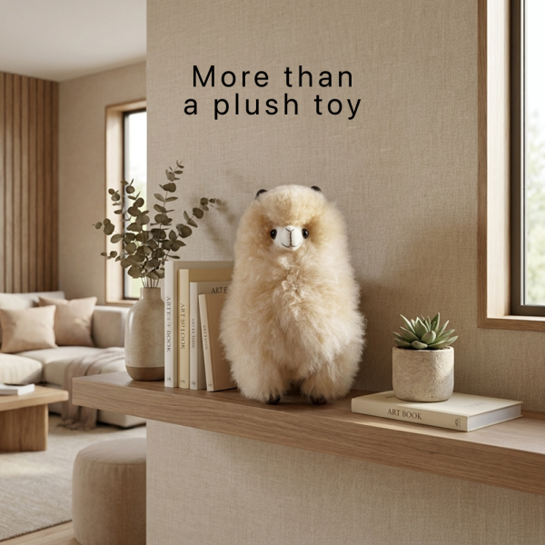 an alpaca plush that is also a decorative statement for a home with the text "more than a plush toy"