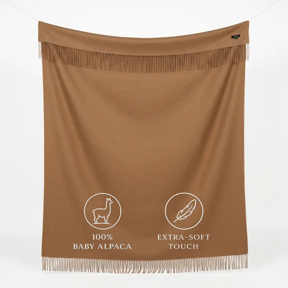 Camel baby alpaca blanket with fringed edges laid flat – premium Peruvian alpaca wool throw in natural camel color