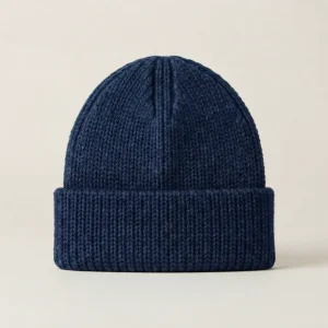 Blue knitted alpaca beanie in a neutral background