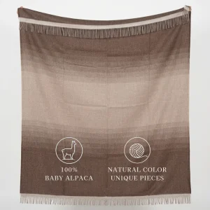 Brown fringed alpaca blanket labeled “100% Baby Alpaca” and “Natural Color Unique Pieces.”