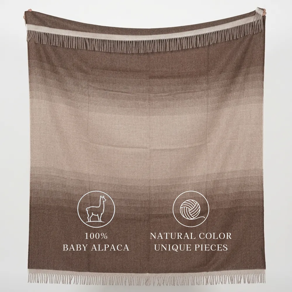 Brown fringed alpaca blanket labeled “100% Baby Alpaca” and “Natural Color Unique Pieces.”