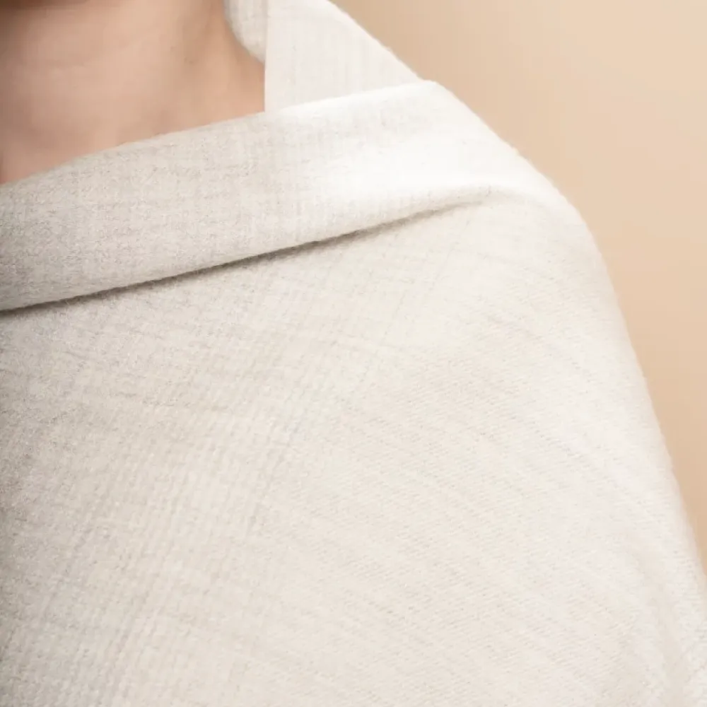 Close-up of a person wearing a gray textured alpaca shawl
