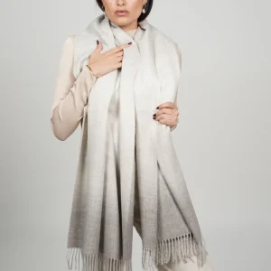 Baby alpaca shawl in grey ombre worn with a cream sweater
