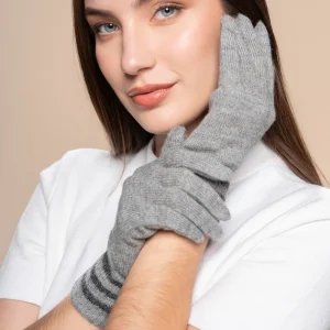Model wearing gray knit alpaca gloves and a white short-sleeve top