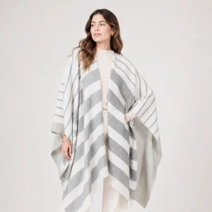 woman wearing an alpaca poncho in gray